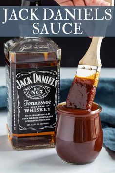 jack daniels sauce in a jar with a wooden spoon