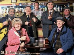 a group of men standing next to each other in front of a bar