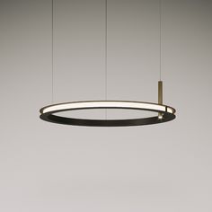 a circular light hanging from the ceiling in an empty room with no one around it