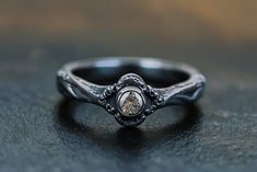 a close up of a ring on a table with a stone in it's center