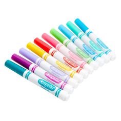 six different colors of markers are lined up in a row on a white background,