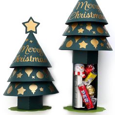 two cardboard christmas trees with gold stars on them, one is green and the other is red