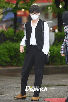 a man wearing a face mask while standing in the street