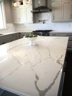 a white marble counter top in a kitchen