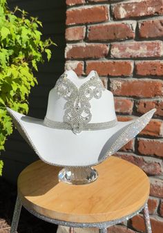 White Tall Crown Hat With Adjustable Fit, White Adjustable Hat With Tall Crown, White Adjustable Tall Crown Hat, Elegant White Hat With Rhinestones, Elegant Silver Hats With Bling, Elegant Silver Hat With Bling, Western Style Fitted Wedding Hat, Western Wedding Hat With Rhinestones, White Party Hat With Rhinestones