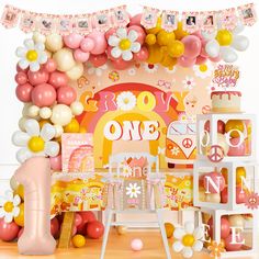 a pink and yellow birthday party with balloons, decorations, and decorating on the wall