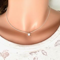 A beautiful small handmade star charm on a sterling silver chain, this star choker necklace made with sterling silver is inspired by how the stars shine with their own light in the sky, each person also has their own special light. This cute and dainty choker symbolize the ethereal and the dreams, the star necklace is a nice gift for star and astronomy lovers. This listing is for one silver star necklace. MADE FROM - Available in 925 Sterling silver. Nikel-free and lead-free. - Chain: Sterling s Star Choker, Star Necklace Silver, Woman Jewelry, Dainty Choker, Star Chain, Graduation Gifts For Her, Celestial Jewelry, Necklace Sterling Silver, Star Charms