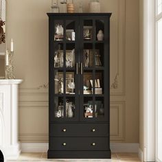 a tall black cabinet with glass doors in a room