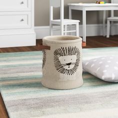 a toy storage basket sitting on top of a rug in a child's room