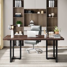 an office desk with a laptop on it and bookshelves in the back ground