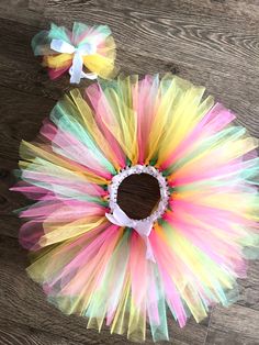 ️ Three coloured fairy tutu outfit.  ️Material Two layers of beautiful, fluffy tulle in three different colours (pink, yellow and green) Elasticated, ribboned waistband Comes with matching tulle hairband.  ️Sizes 0-3 years up to 52 cm waist  3-6 years 52cm to 56 cm waist ️All skirts  0-1 year will have a 5 inch drop.  1-2 years a 6 inch drop.  2-3 years a 7 inch drop  All skirts 3-6 will have a 10inch drop unless otherwise requested.  (Colours may vary slightly) ️Beautiful, bespoke, delicately h Sweet Multicolor Tutu Dress For Spring, Spring Fairy Style Tutu Dress With Tulle Skirt, Sweet Tulle Tutu Dress For Birthday, Cute Multicolor Tutu Dress For Easter, Whimsical Tutu Dress With Tulle Skirt For Birthday, Multicolor Tulle Tutu Dress For Easter, Fairy Style Tulle Tutu Dress With Ruffles, Multicolor Tulle Fairy Dress For Birthday, Fairy Style Tulle Tutu Dress For Birthday