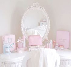 a white vanity with pink accessories on it