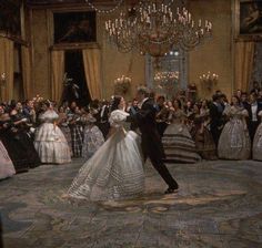 a bride and groom dancing in front of a crowd