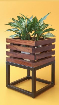 a wooden planter sitting on top of a metal stand