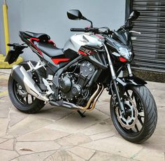 a black and silver motorcycle parked in front of a building