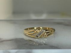 For the modern woman, sleek and minimalist gold bangles have become a favorite choice. With clean lines and subtle details, these designs exude sophistication while being understated enough for daily wear. Ladies Engagement Rings Gold, Yellow Gold Rings Fashion, Mens Rings Gold Indian, Ladies Finger Rings Gold, Ladies Ring Gold, Modern Gold Ring Design For Women, Gold Ring For Ladies, Women Rings Gold Design, Gold Ring Design For Women Indian