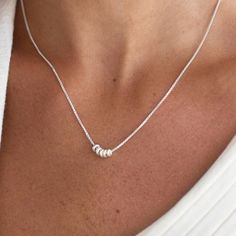 This is a stunning women's silver plated necklace will make a timeless addition to your collection. Featuring five tiny silver rings, this necklace makes a simple statement on its own, or can be layered with your other favorite silver neck wear. A classic and beautiful necklace that will suit any style of clothing, everyday or event.  Water resistance. Item will arrive in a pretty gift wrap, ready to give, with my brand logo. If you wish to view more silver necklaces - https://www.etsy.com/shop/jewelryforher2018?section_id=24105111 if you wish to view more items from this shop, visit: https://www.etsy.com/shop/jewelryforher2018 M3000022 / WN081 Silver Boho Necklace, Silver Necklace Simple, Necklace Bead, Layered Necklaces Silver, Silver Bead Necklace, Gold Bead Necklace, Bead Pendant, Beaded Pendant Necklace, Mothers Necklace