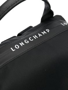 Le Pilage Energy backpack from LONGCHAMP featuring black, single rounded top handle, adjustable shoulder straps, top zip fastening, main compartment, asymmetric body and rear zip-fastening pocket. | Longchamp Le Pilage Energy backpack Longchamp Aesthetic, Longchamp Le Pliage Energy, Longchamp Bags, Recycled Canvas, Canvas Backpack, Strap Tops, Longchamp Le Pliage, Black Backpack, Travel Bag