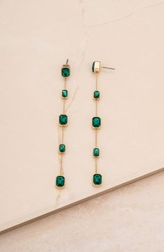 Dainty baguette-cut crystal stations bring elegant sparkle to linear drop earrings crafted from lustrous 18-karat-gold plate. 4" drop; 1/4" width Post back Glass/18k-gold plate Imported Cocktail Jewelry Earrings, Good Drop Earrings, Forest Green Earrings, Emerald Gold Earrings, Green Wedding Jewelry, Emerald Cut Earrings, Emerald Drop Earrings, Unique Dangle Earrings, Emerald Earrings Drop