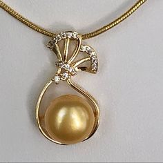 Gorgeous 10-11mm Real Genuine Golden Cultured Pearl 18kt Gold Filled Pendant Necklace. Small Stones On Pendant Are Cubic Zirconia. Chain Measures 20” Inches. New Condition And Comes In A Gift Box. Bundle & Save: Bundle 2 Or More Items For A Private Discount Next Day Shipping On All Orders 5 Star Rated Poshmark Ambassador Exquisite Gold Pearl Necklace For Anniversary, Gold Pearl Necklace With Diamond Accents, Gold Diamond Pearl Necklace Fine Jewelry, Classic Gold Diamond Pearl Necklace, Elegant Gold Pearl Necklace Hallmarked, Exquisite Yellow Gold Round Pearl Necklace, Gold Pearl Necklace With High Luster Round Pendant, Gold Akoya Pearl Jewelry With Diamond Accents, Gold Jewelry With Diamond Accents And Akoya Pearl