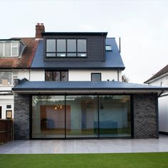 a modern house with large glass doors and windows