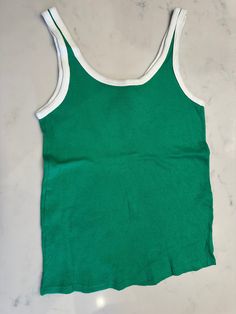 Cotton stretch knit tank top in green. 70s white rib knit crewneck and armscye. Size fits medium. Green Cotton Sporty Tank Top, Green Scoop Neck Tank Top For Everyday, Everyday Green Scoop Neck Tank Top, Vintage Ribbed Crew Neck Tops, Spring Green Crew Neck Tank Top, Retro Fitted Crew Neck Tank Top, Fitted Retro Crew Neck Tank Top, Sporty Green Scoop Neck Top, Retro Green Sleeveless Tank Top