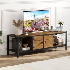 a flat screen tv sitting on top of a wooden cabinet