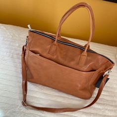 Rare Find! Still Nordic - Stillanouk Weekend Bag Cognac Genuine Leather 100% Leather With 100% Cotton Classy And Chic Design Where The Leather Quality Is So Soft And As Time Goes By It Becomes Even Softer. On Both Sides Of The Bag You'll Find Roomy Pockets With Zip Closure (One Hidden And One Exposed - See Pics For More Of The Details) Inside The Bag Has Multiple Pockets And A Padded Section For A Computer. Included Is A Detachable Leather-Strap That Also Enables You To Carry As A Crossbody Bag. See Pics For Approx Measurements: 18in Long 14in Tall 8in Wide Caramel Leather Shoulder Bag With Removable Pouch, Dark Tan Rectangular Satchel For Travel, Dark Tan Rectangular Travel Satchel, Caramel Travel Shoulder Bag With Removable Pouch, Caramel Shoulder Bag With Removable Pouch For Travel, Brown Travel Bag With Removable Pouch For Shopping, Brown Travel Bag With Detachable Strap For Everyday Use, Cognac Rectangular Travel Bag For Everyday Use, Rectangular Cognac Travel Bag For Everyday Use