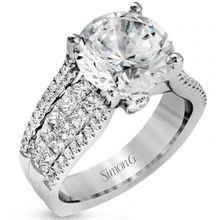 a diamond engagement ring with two rows of diamonds on the band and an oval shaped center stone