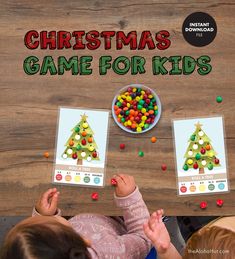 two children sitting at a table with christmas game cards in front of them and the text, christmas game for kids