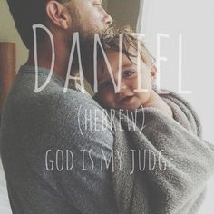 a man holding a baby wrapped in a blanket with the words, daniel hebrew god is my judge