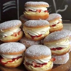 a pile of doughnuts sitting on top of a wooden table