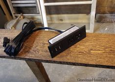 a power strip sitting on top of a wooden table