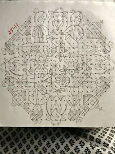 a piece of paper with drawings on it and some black dots in the middle,