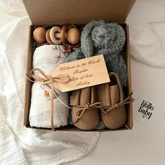 a box filled with baby shoes and blankets