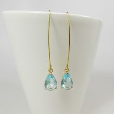 Aqua Blue Drop Earrings, Gold Aquamarine Teardrop Earrings, Long Dangle Earrings, Wedding Jewelry, Bridesmaid Gift, Long Drop Earrings. These beautiful and elegant long dangle drop earrings made with high quality, sparkly 24k gold framed, faceted aqua blue teardrop glass crystals hang from tarnish resistant long oval gold plated ear hooks. These earrings are classic and elegant. Will make an excellent gift for yourself or friends. Measurements: The total length from the top of the hook to bottom Gold Briolette Teardrop Earrings For Wedding, Delicate Teardrop Linear Earrings For Anniversary, Yellow Gold Teardrop Linear Earrings For Wedding, Wedding Yellow Gold Linear Teardrop Earrings, Yellow Gold Dangle Threader Earrings For Wedding, Wedding Yellow Gold Drop Threader Earrings, Yellow Gold Drop Linear Earrings For Wedding, Yellow Gold Long Drop Earrings For Wedding, Elegant Teardrop Threader Earrings For Wedding