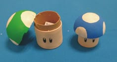 two toilet paper rolls with mario mushroom heads on them