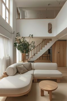 a living room filled with furniture next to a stair case