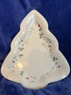 a white christmas tree shaped dish on a blue background