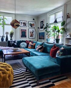 a living room filled with lots of furniture next to a large painting on the wall