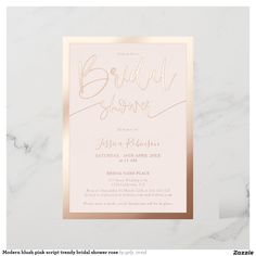 a pink and gold bridal shower card on a white marble background with the words bridal shower written in cursive font