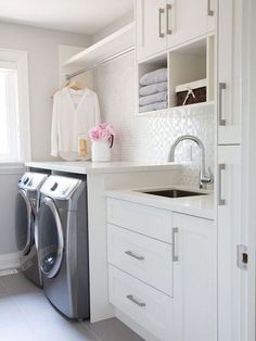 a washer and dryer in a white laundry room