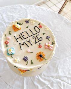 a white cake with flowers and the words hello my 28 on it sitting on a table