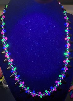 20-inch neon and black spike necklace. Multi colored neon beads and black accent beads. Everything but the black spike beads glows fiercely under UV/black light as shown! Black Glow In The Dark Jewelry For Parties, Black Glow In The Dark Party Jewelry, Neon Necklace, Uv Black Light, Spike Necklace, Black Light, Black Accents, Beaded Jewelry Diy, Lei Necklace