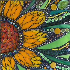 an art work made with glass and beads on the side of a sunflower flower