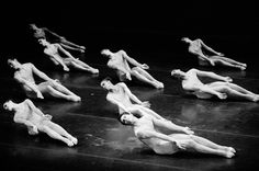 the dancers are all laying down on the floor and doing different things in black and white