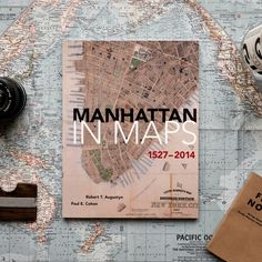 a map with the words manhattan in maps next to some other items on top of it