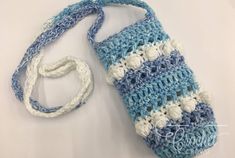 a crocheted blue and white handbag with a lanyard attached to it