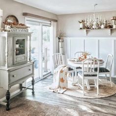 a dining room table with chairs and a china cabinet