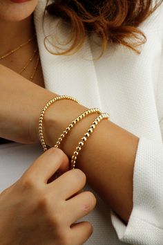 14k Gold Filled Tarnish Resistant Beaded Ball Bracelet.  A Minimalist Gold Bracelet That You Can Wear on Its Own or Layer up. Your Perfect Everyday Companion. If You Are Looking for A Quality Bracelet that Keeps its Shine, this is Ideal For You. Stretch to fit variety of wrist sizes Tarnish Resistant and Hypoallergenic Bracelet. DIMENSIONS Material: 14k Gold Filled Ball Bead Sizes 1) 3mm 2) 4mm 3) 5mm Bracelet Length: Fits comfortably for up to 7.5 Inch Wrist diameter What is 14K Gold Filled? '' Minimalist Gold Bracelet, Gold Ball Bracelet, Bracelets Dainty, Beaded Ball, Stacking Bracelets, Gold Armband, Ball Bracelet, Rose Gold Bracelet, Layered Bracelets